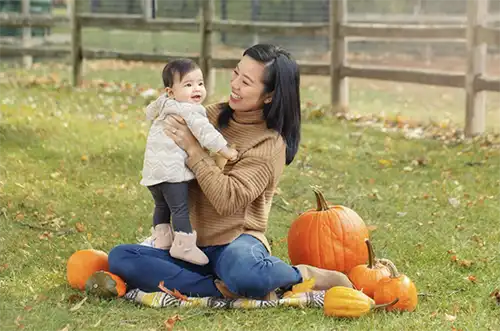 Mom with baby girl and pumpkins