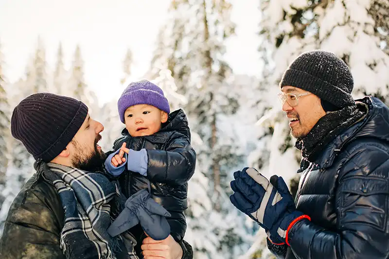 parents and baby in snow
