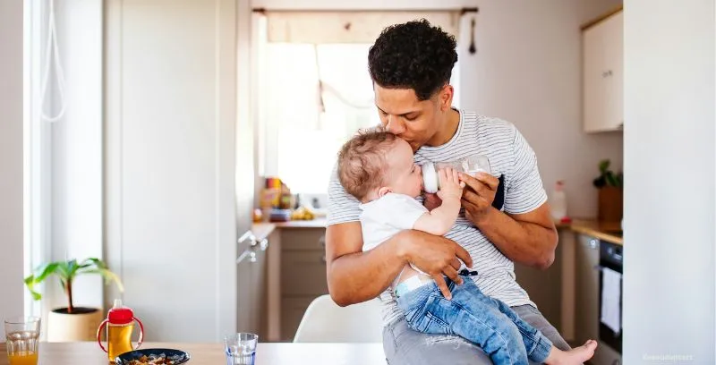 dad feeding baby