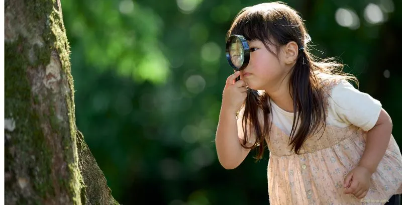 girl with magnifying glass