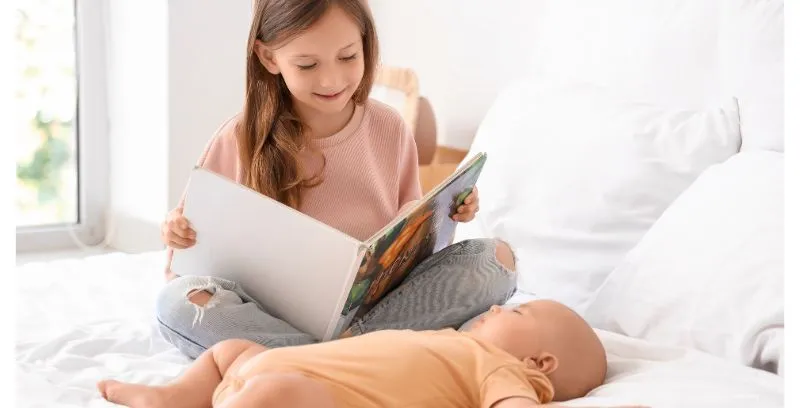 sibling reads to baby